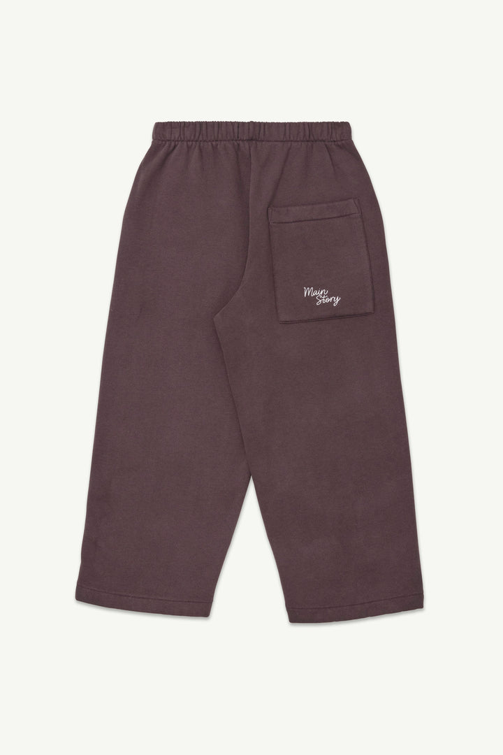 A pair of dark cherry-colored lounge pants with an elastic waistband and a small white embroidered logo on the back pocket.