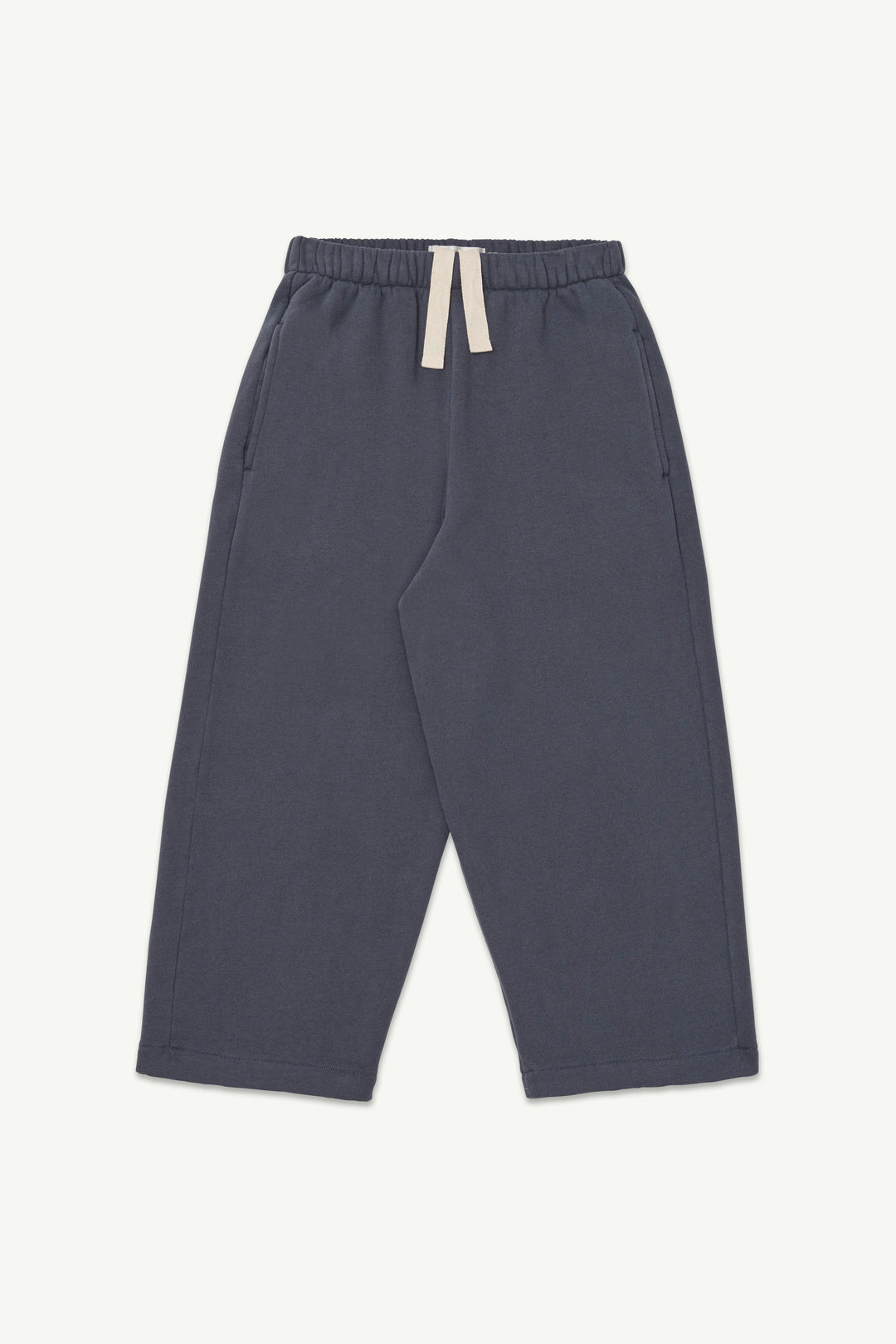 A pair of graphite blue lounge pants with an elastic waistband and a contrasting off-white drawstring.