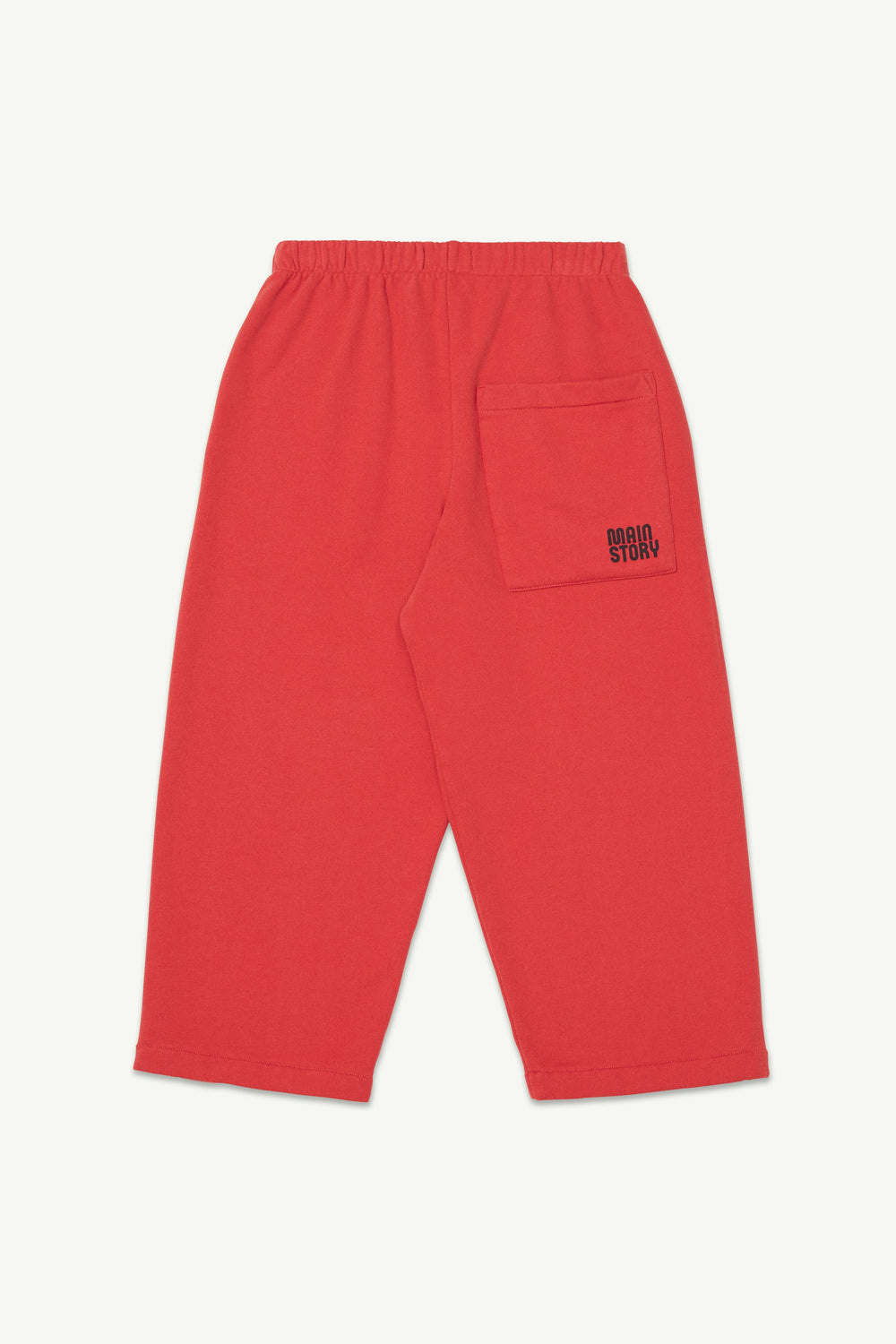 Back view of red lounge pants with an elastic waistband, with a small brand logo on the back pocket.