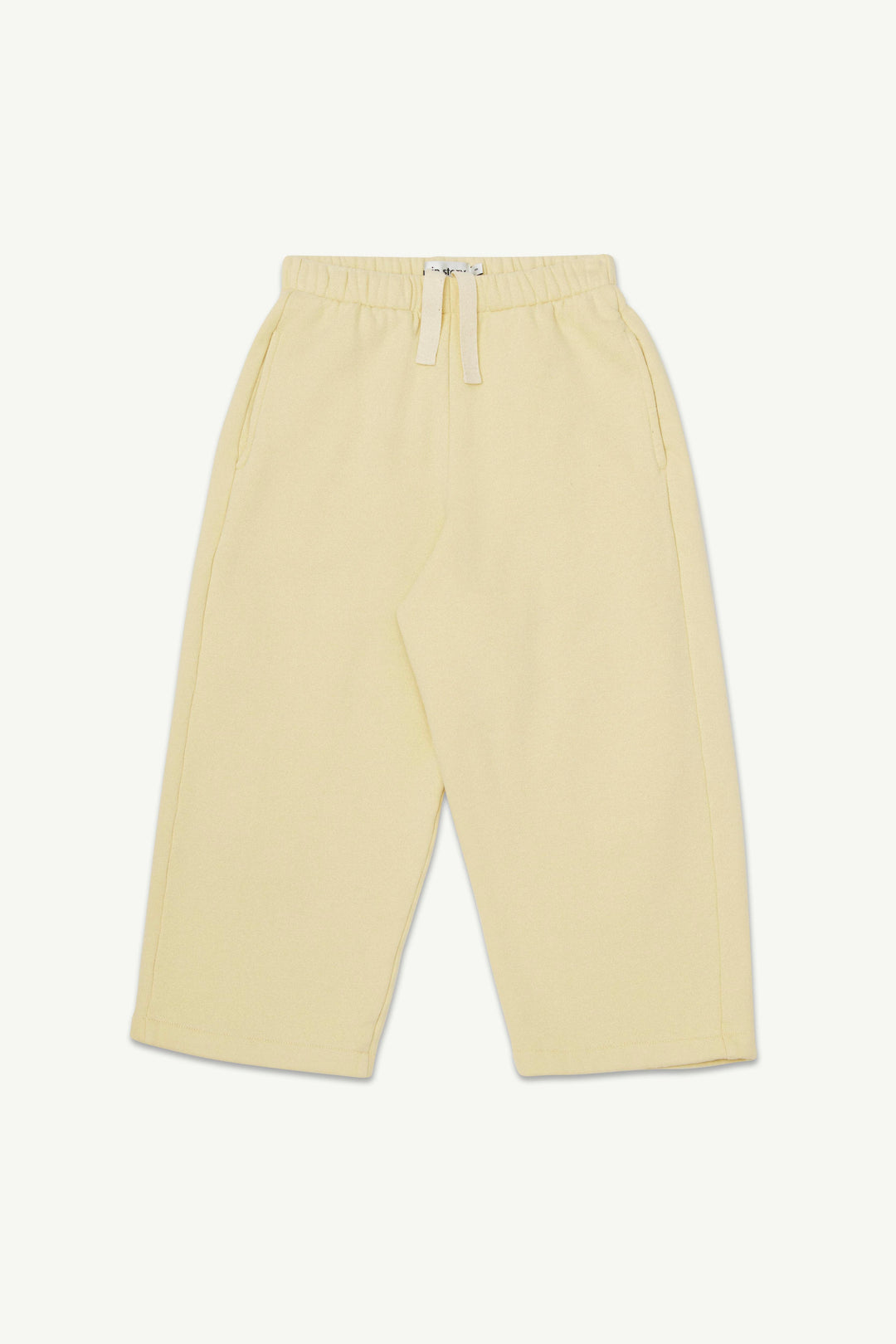 A pair of pale yellow lounge pants with an elastic waistband and drawstring.